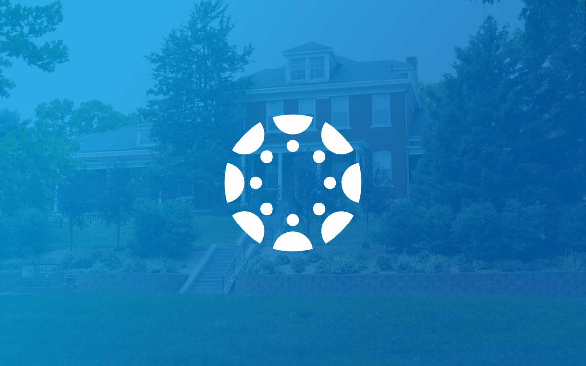 The Canvas logo sits in the center of the image, and behind it, there is a blue background that is slightly faded and shows a building from the Fort Omaha campus.